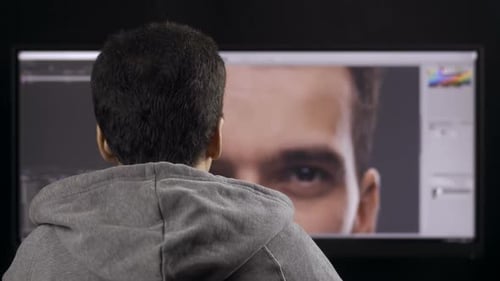 Young Adult Working on Male Portrait on Computer