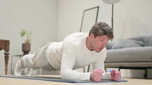 Man Doing Plank on Yoga Mat at Home