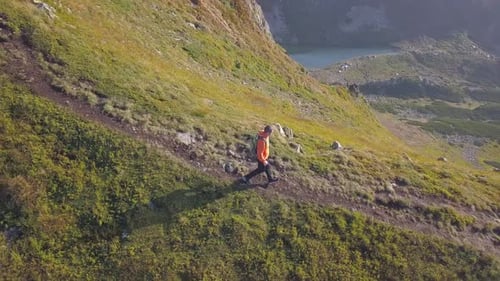 Tourist Hiker with a Backpack Running on Mountain Path in Carpathian Mountains