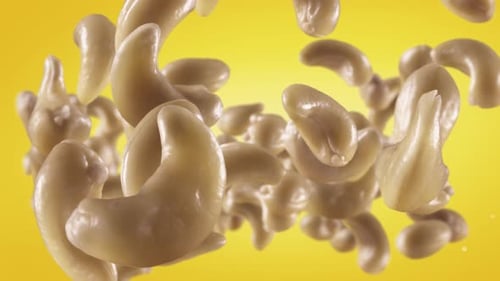 Realistic Cashew Nuts Falling Against Yellow Background