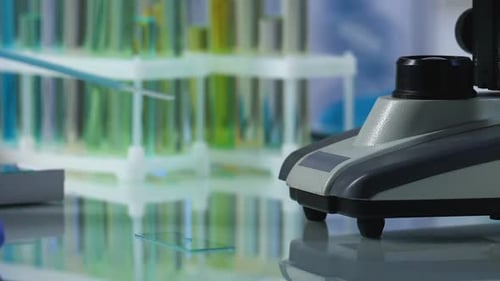 Scientist Drops Reagent to Slide Glass With Pipette to Examine Under Microscope