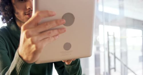 Man using digital tablet in cafe