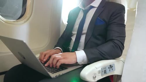 Typing on Laptop While Flying in Airplane