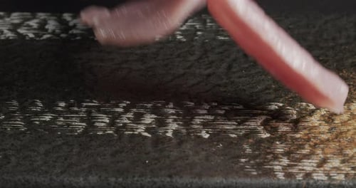 Thinly Cut Meat Slices Arranged on Board