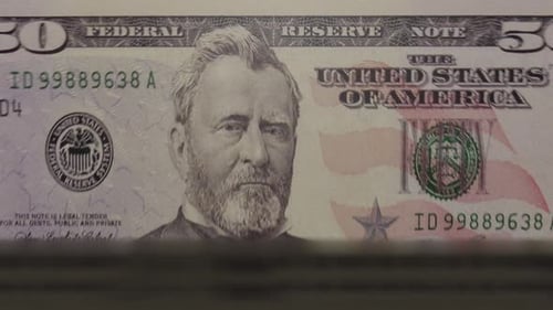 Fifty Dollar Bills Being Counted by Machine