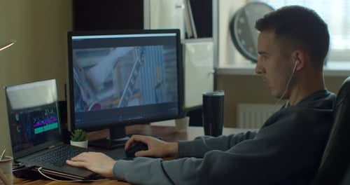 Man Working on Computer with Two Monitors Video Editing. Monitor the Computer and Capture the Work