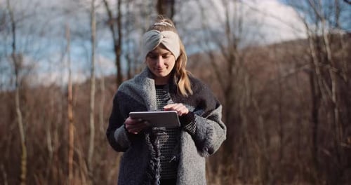 Female Tourist Taking Brake in Mountains and Use Digital Tablet