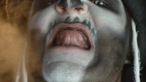 Man with Scary Skull Makeup Snarls and Emits Smoke