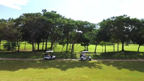 4K Aerial view group of Asian people golfing on at golf course in summer sunny day.