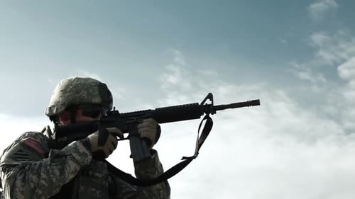 Soldiers on firing line practicing readying and firing M4 assault rifles