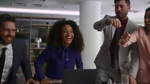 Cheerful Business Team Celebrates Success in Office