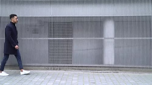 Side view of businessman walking on footpath