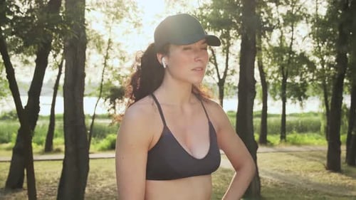 Woman in Sports Bra Smiling in City Park
