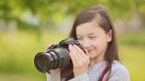 Girl Taking Pictures With Camera in Park