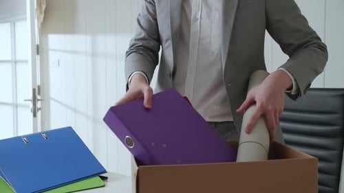 Man Packs Belongings After Being Laid Off