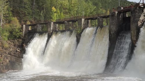 Water Dam in the Forest Heavy Water Stream Falls Down the Brick Wall