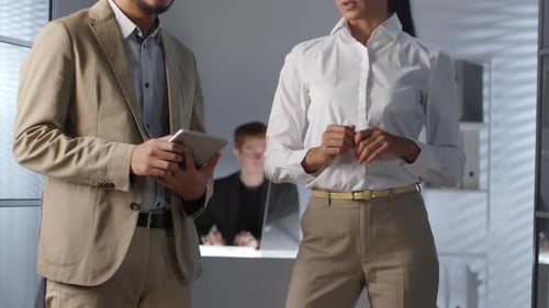 Colleagues Using Invisible AR Interface and Digital Tablet in Office