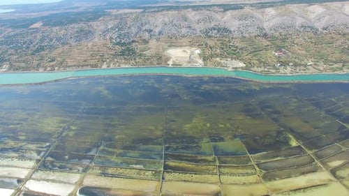 Aerial view of salt pans surrounded by sea and mountains, Pag island, Croatia