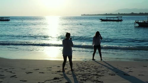 Bermuda islands, Best friends on the vacation taking photos with the smartphone on the sandy beach