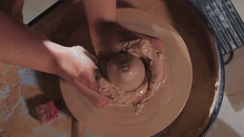 Hands Shaping Clay on Pottery Wheel
