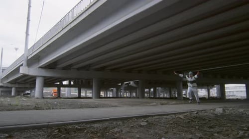 Parkour Athletes Perform Acrobatic Stunts Under Overpass