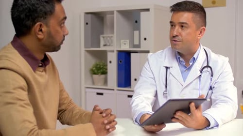 Male Doctor with Tablet Pc and Patient at Hospital 23