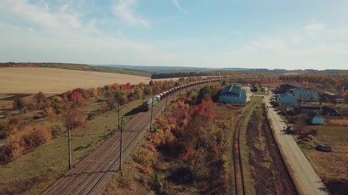 Freight Train Travels Through Rural Autumn Landscape