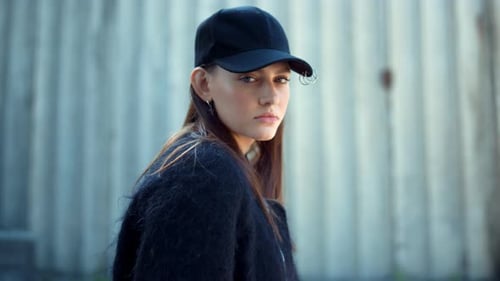 Girl Standing on City Street. Fashionable Woman Posing at Camera