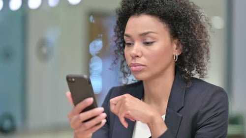 African Businesswoman Using Smartphone Chatting Online