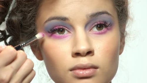 Hand of Visagist Applying Eyeshadow.