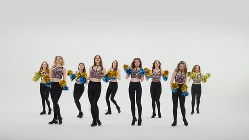 Group of Athletic Cheerleaders in Silver Tops and Black Tight Leggings are Dancing Cheering Dance on