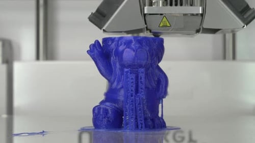 3D Printer Creates Blue Figurine Object