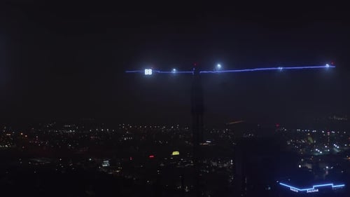 City at Night with Lit Construction Crane