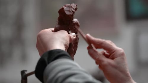 Hands Shaping Clay into Art Sculpture
