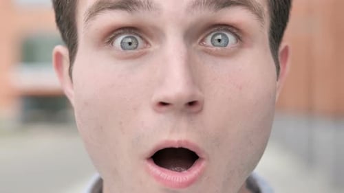 Outdoor Close up of Wondering Young Man Face
