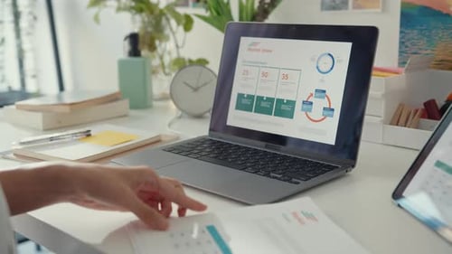 young asia lady freelance focus on work finance graph account chart market plan in laptop.