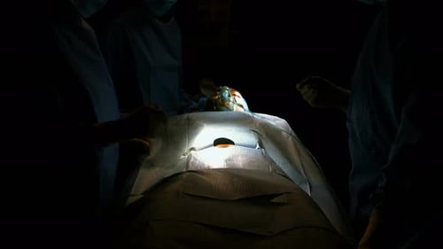 Surgical Team Performing Operation in Dark Room