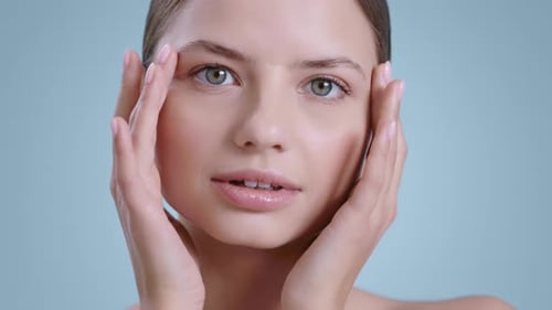 Beautiful Young Woman Touches Her Face