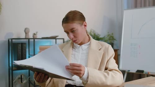 Business Woman at Home Office Analysing Paperwork Documents Shocked By Sudden Victory Good News Wow