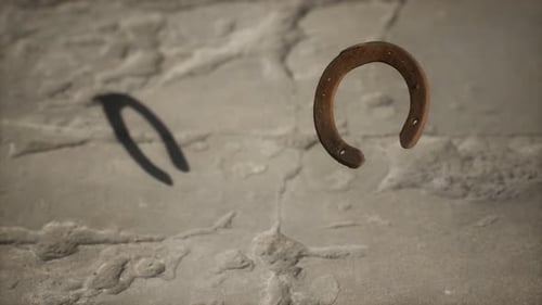 Realistic Rusty Horseshoe Floating Down on Stone Floor