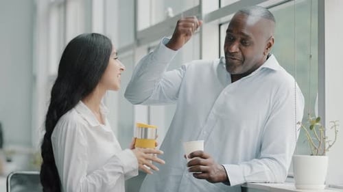 Business Colleagues Talking During Coffee Break in Office