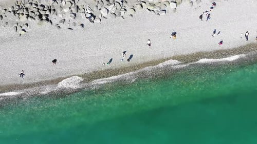 Aerial View of People Crowd Relaxing on Beach and Sea with Waves. Top View From Flying Drone.