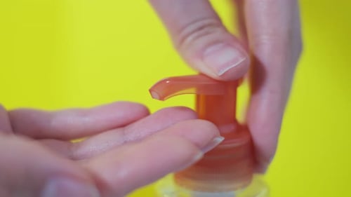 Cream Dispensed from Bottle onto Hand, Close Up