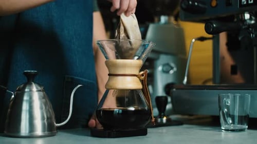 Process of making espresso in a coffee machine. Barista making latte in specialty coffee shop.