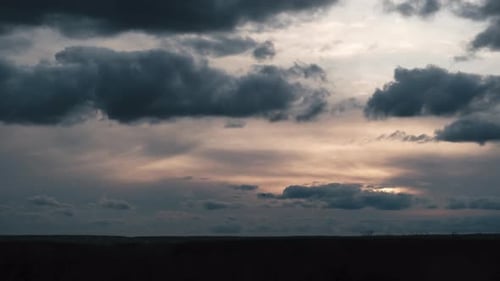 Clouds in the Sky Move Against the Background of the Sun at Sunset Timelapse