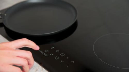 Turning on a modern induction cooktop