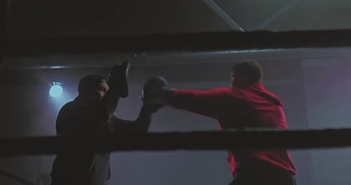 Men Boxing Training Inside Ring at Night