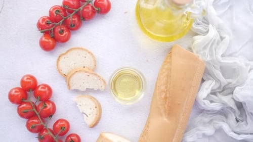 Bread Tomato and Olive Oil on Table