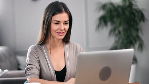 Young Woman Working on Laptop at Home