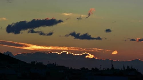 Sun Setting Behind Silhouetted City Landscape